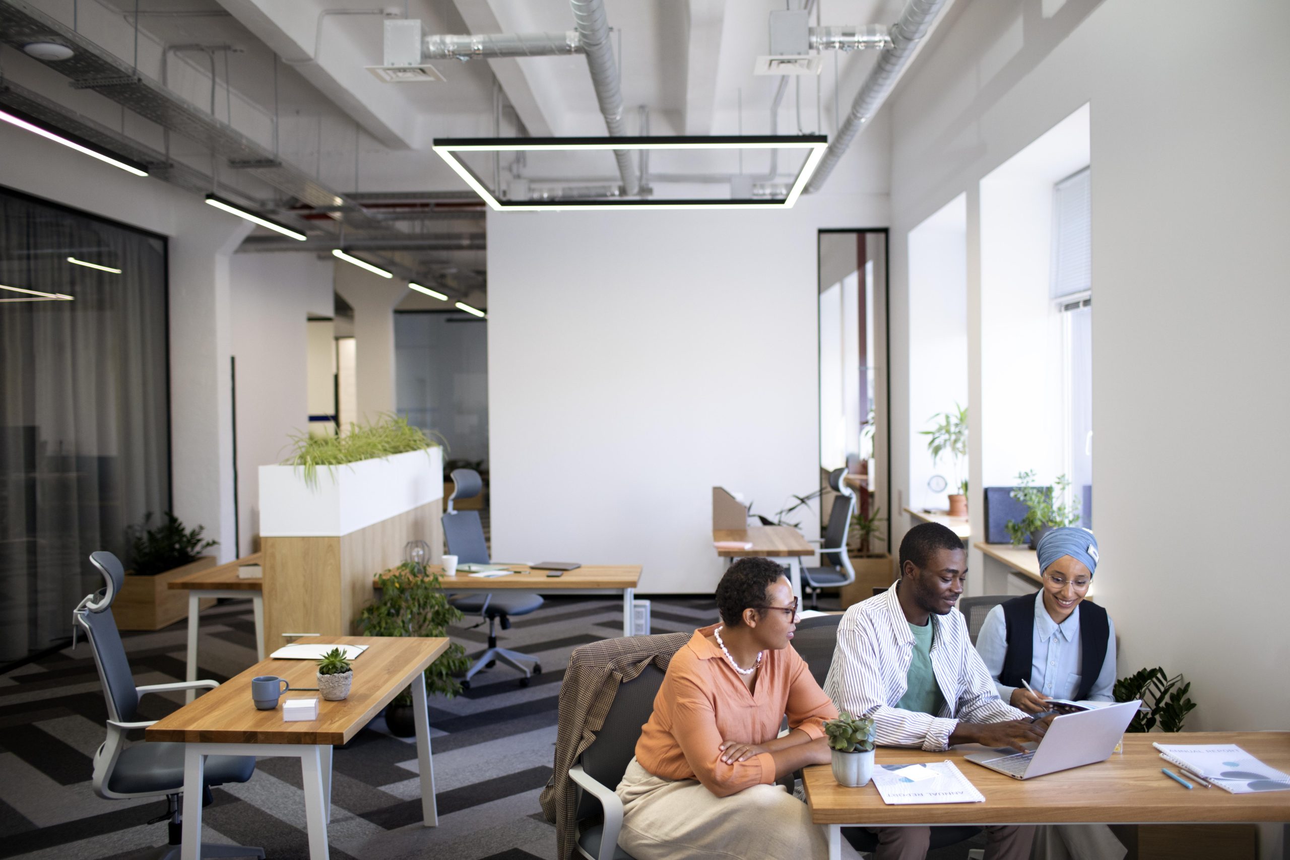 male-employee-getting-used-his-new-office-job-along-with-female-colleagues-scaled